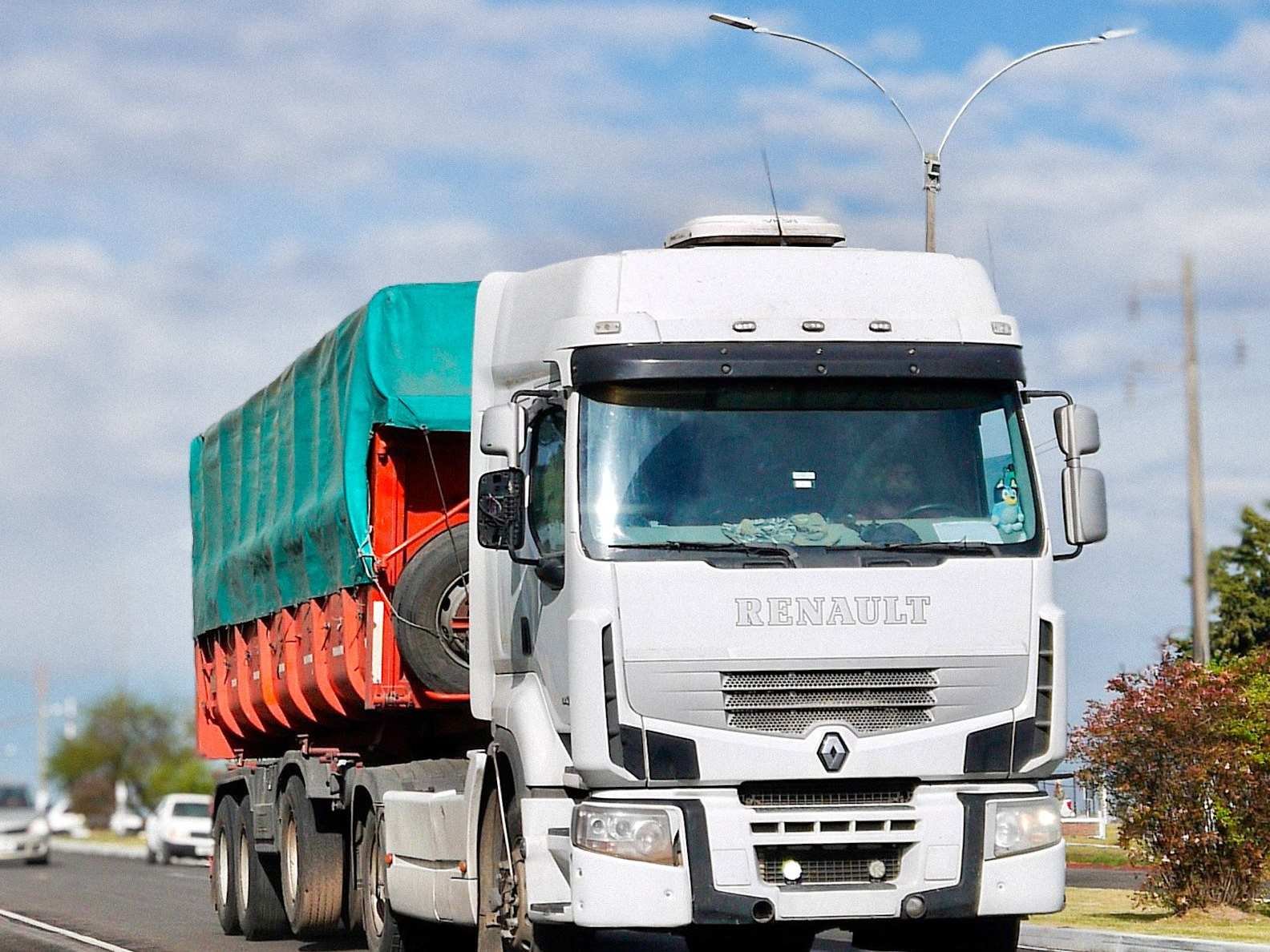 White Renault semi-truck hauling a large trailer for a hauling service