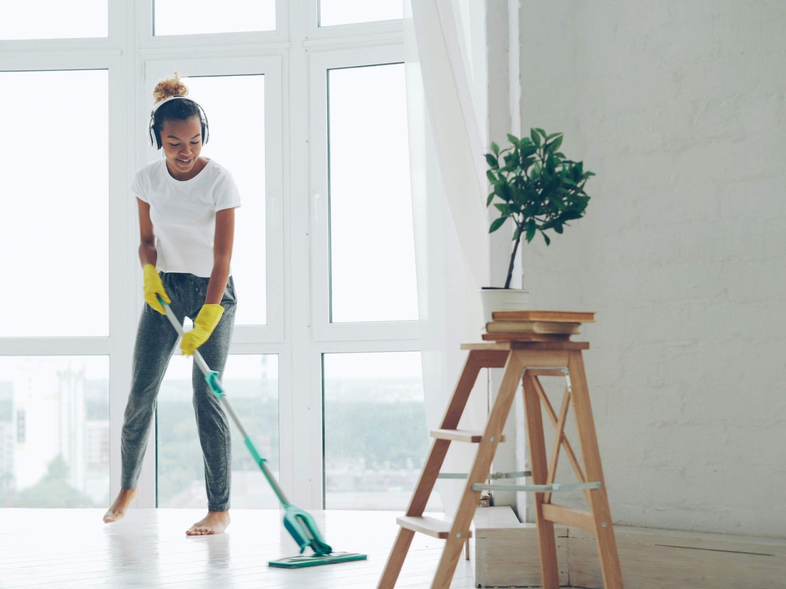 Woman cleaning a room with a mop during a property cleanout
